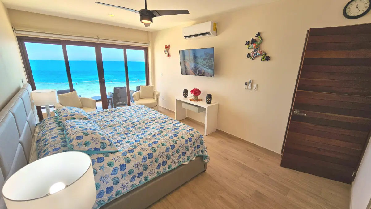 Master bedroom with king bed and ocean view
